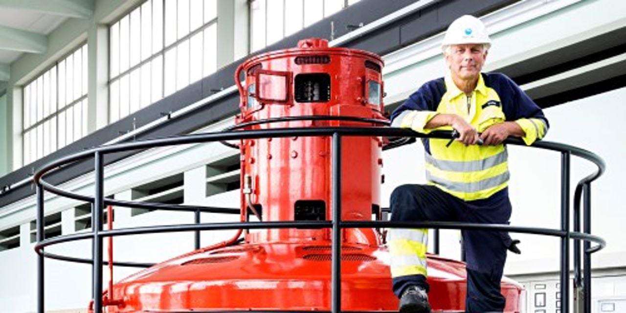 Man standing in the machine hall of a hydropower plant